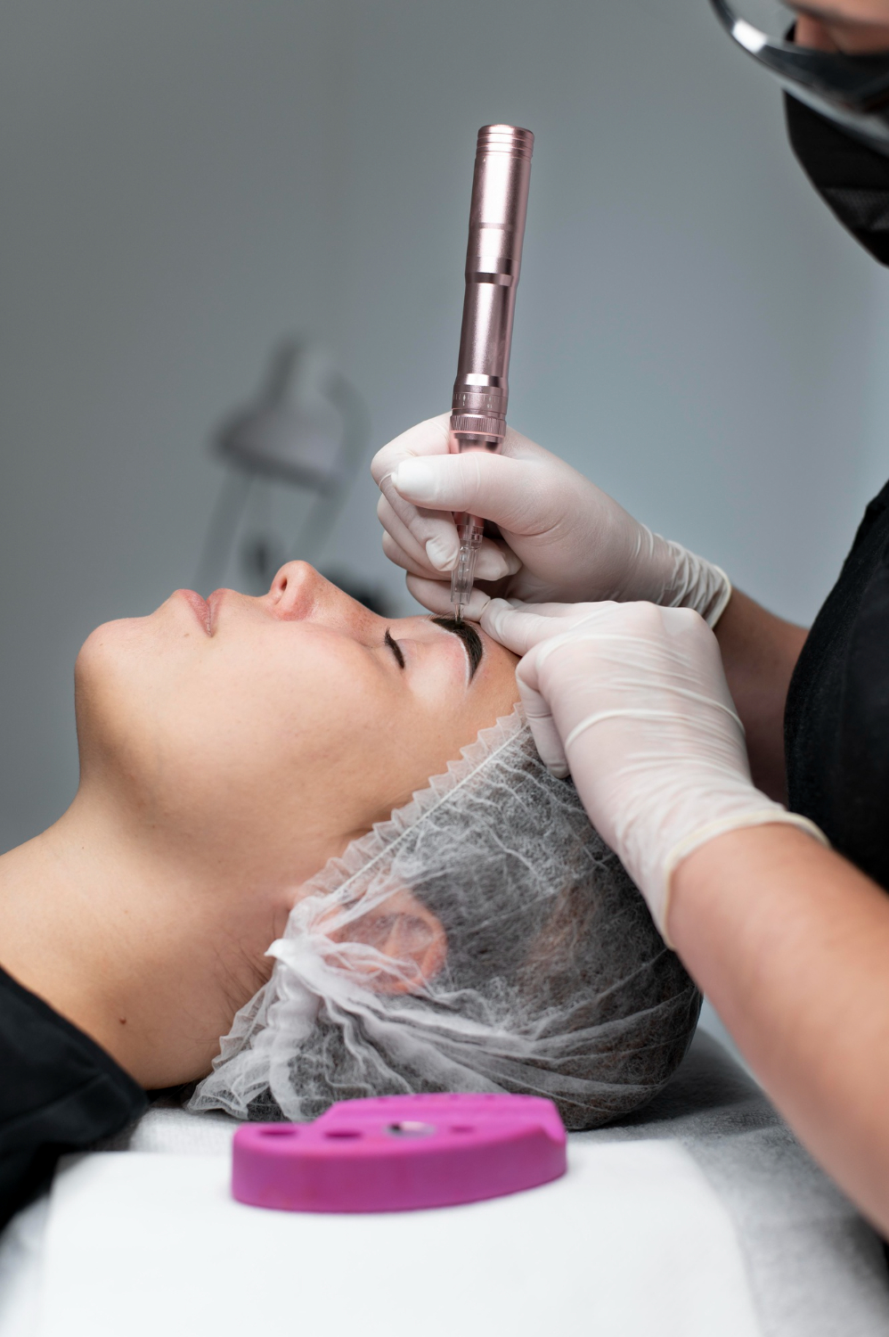 a woman getting her eyebrows done