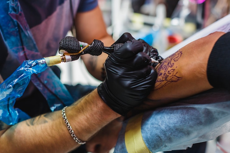 hand-drawing-tattoo-with-needle_23-2147833995